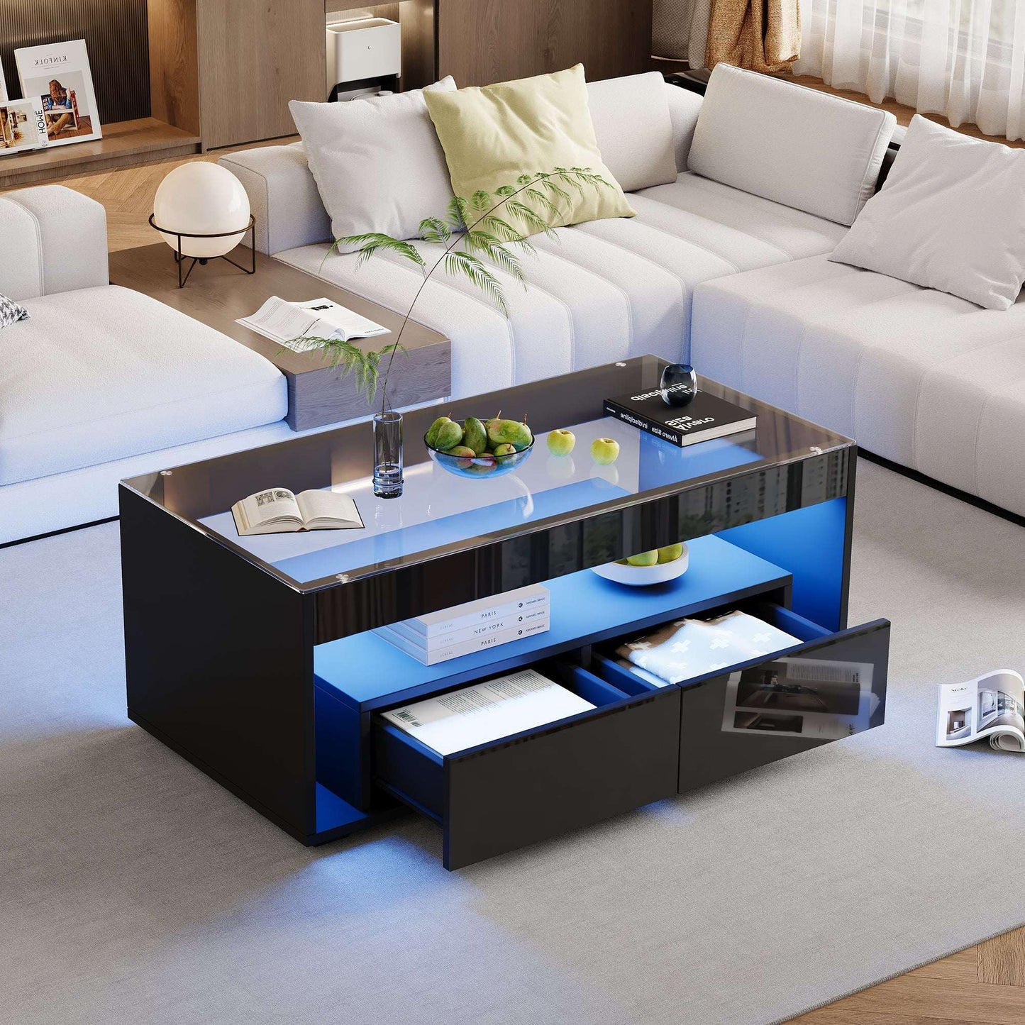 Modern living room with a black and blue coffee table, white sofa, and decorative items.