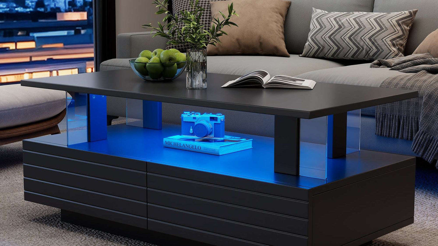 Modern living room with a black coffee table featuring blue LED lighting, a gray sofa, and decorative items.