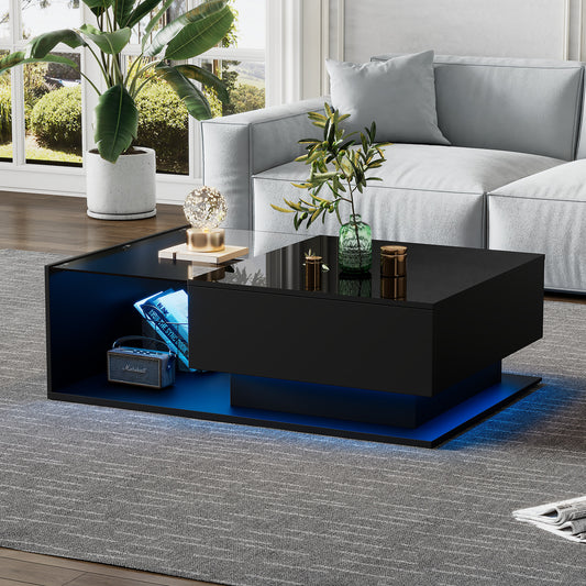 Modern living room with a black coffee table, gray sofa, and decorative plants.