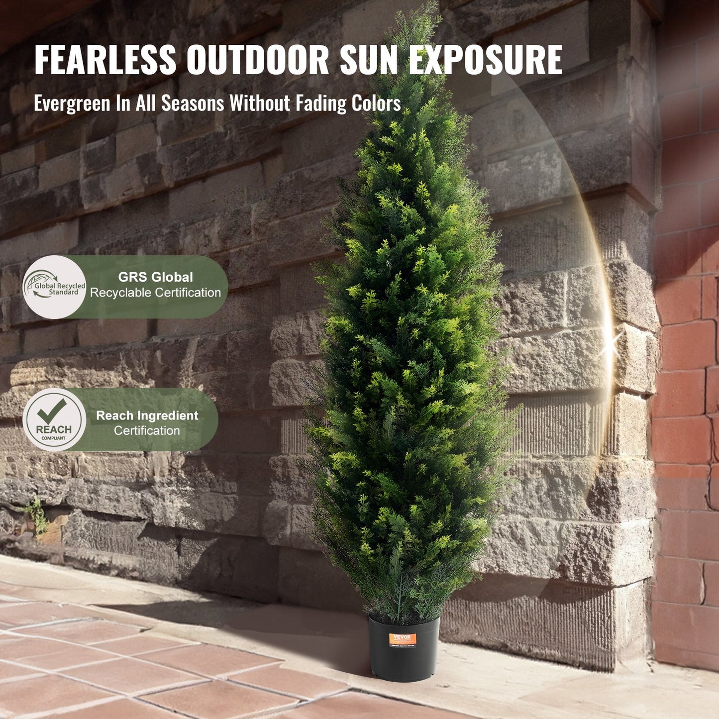 Artificial evergreen tree in a pot against a stone wall with certification logos displayed. UK-24BIZHUB