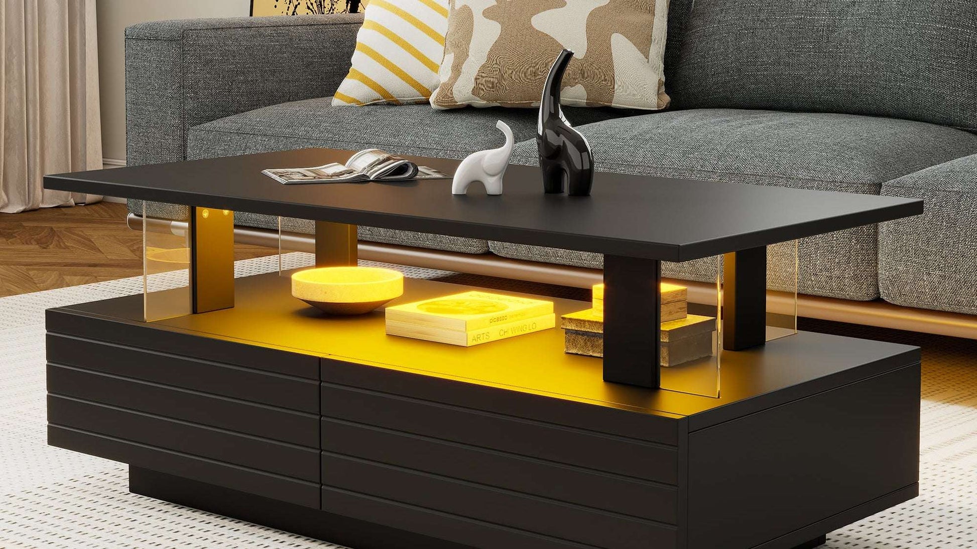 Modern black and yellow coffee table in a living room setting with a gray sofa and decorative pillows.