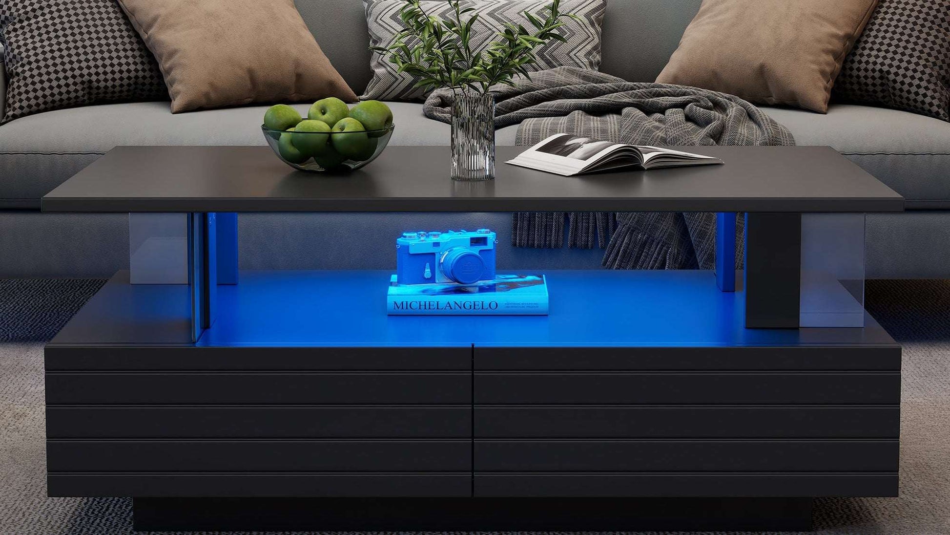 Modern living room with a gray sofa and a black coffee table with blue LED lighting.